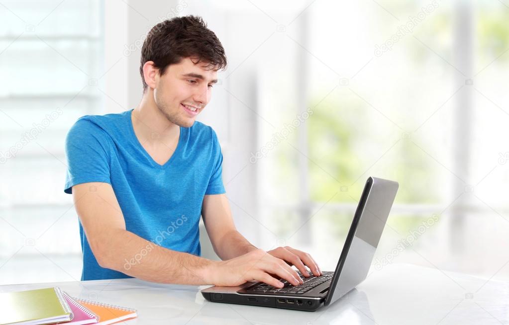 College student using his laptop Stock Photo by ©odua 42960015
