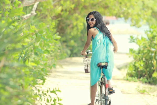 Mujer divirtiéndose montando bicicleta en la playa —  Fotos de Stock