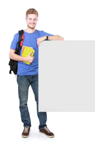Young male student holding white blank board — Stock Photo, Image