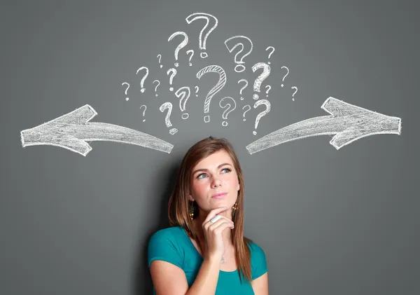 Woman making a decision with arrows and question mark above her — Stock Photo, Image