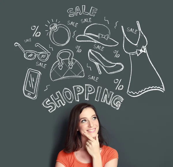 Woman looking up thinking of buying or shopping something — Stock Photo, Image