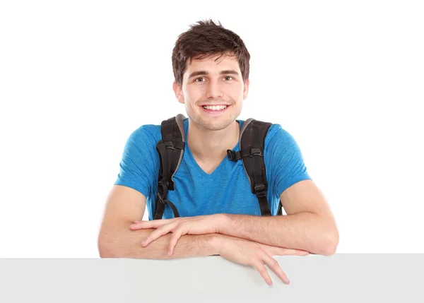 Joven estudiante masculino sosteniendo blanco tablero en blanco — Foto de Stock
