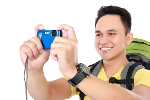 Male hiker with backpack using mobile phone — Stock Photo, Image