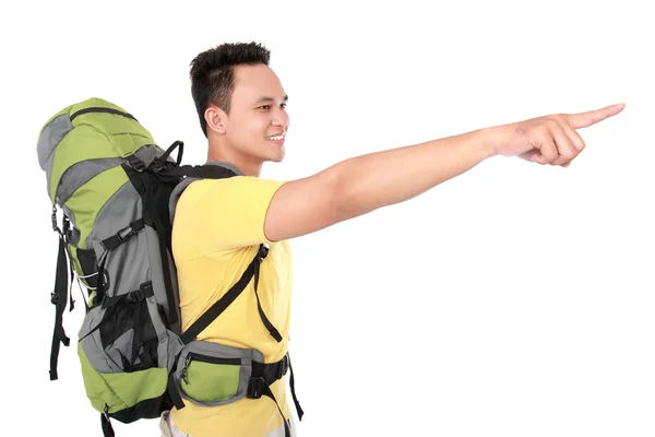 Man with backpack pointing to the direction with hand — Stock Photo, Image