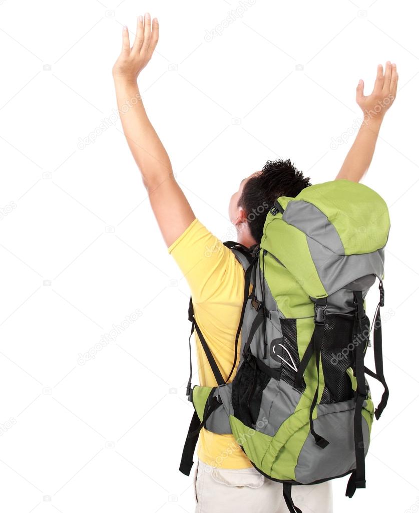 male hiker with backpack raised his arm