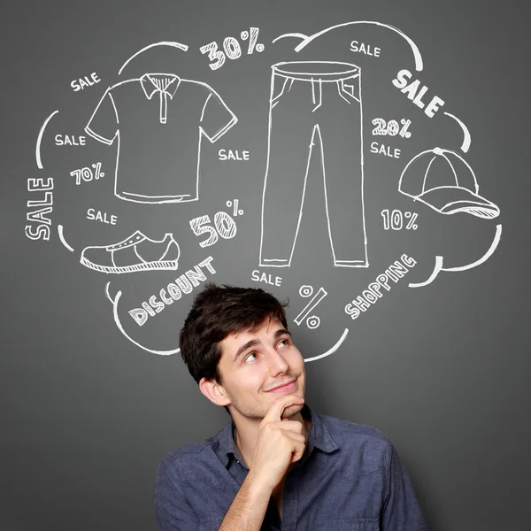 Man looking up thinking of buying something — Stock Photo, Image