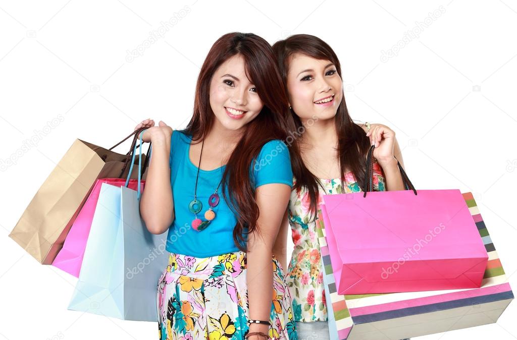 two young woman happy holding shopping bags