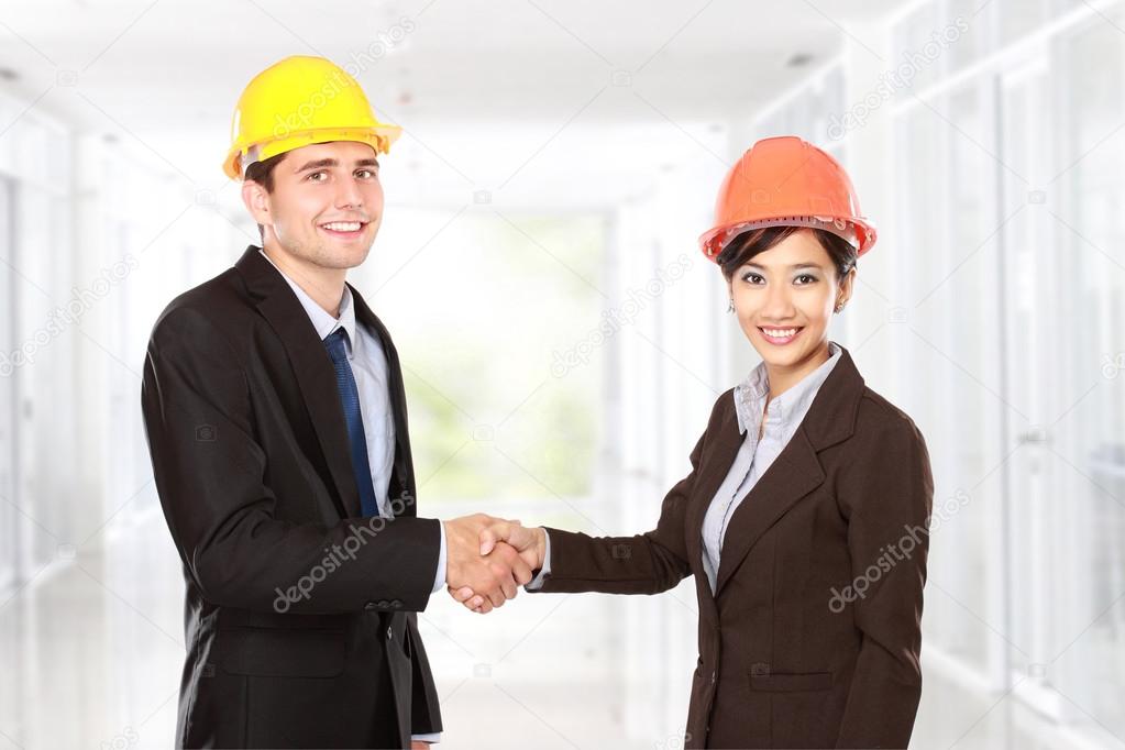 shaking hands at construction site