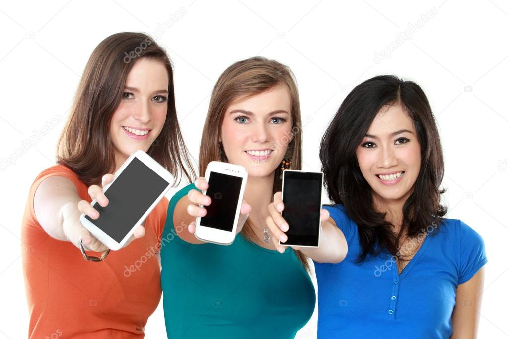 female friends showing their mobile phones