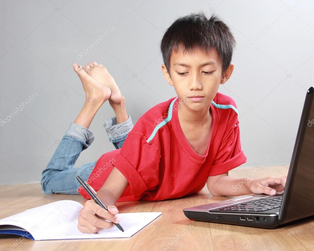 kid studying with books and laptop