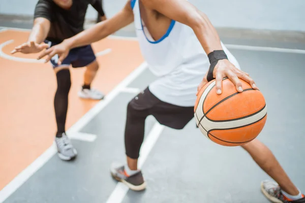 Basketball players hand carrying a ball with a high dribbling technique