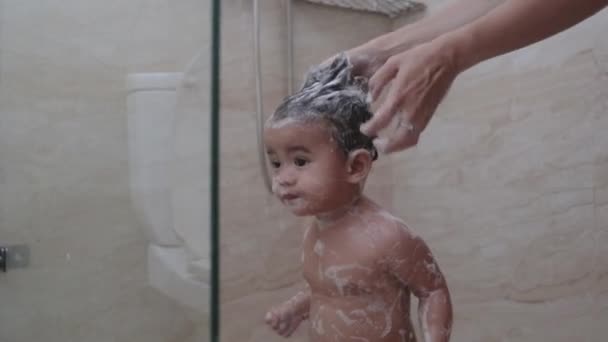 Asian toddler taking shower in bathroom washing hair — Stock Video © odua #515843700