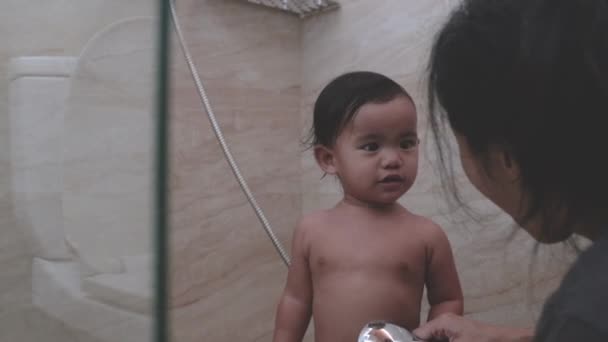 Asian toddler taking shower in bathroom — Stock Video © odua #515872796