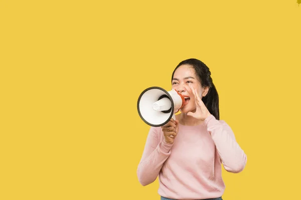 Young woman holding megaphone to shout with hand gesture — Stock Photo, Image