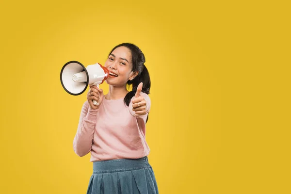 Beautiful woman talking holding megaphone and thumbs up camera with copyspace — Stock Photo, Image