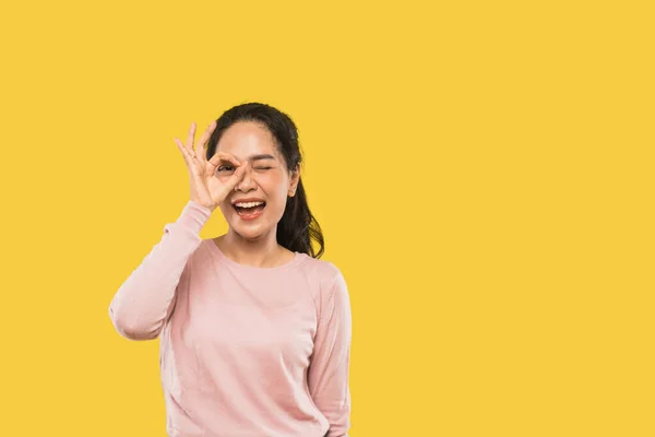 Happy young asian woman with okay hand gesture in one eye — Stock Photo, Image