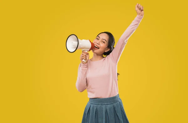 Cute girl shouting with opening mouth during making announcement using megaphone — Stock Photo, Image