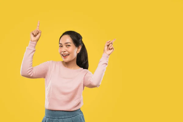 Beautiful young asian woman with two hands pointing up — Stock Photo, Image
