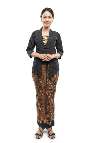 Attractive young woman wearing Kebaya standing on isolated background — Stock Photo, Image