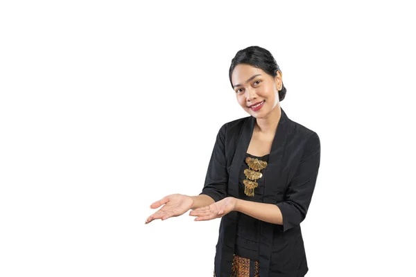 Beautiful woman wearing traditional Javanese clothes presenting — Stock Photo, Image