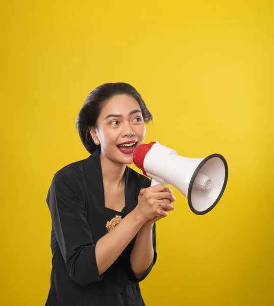 Close up of Asian woman wearing Kebaya talking using megaphone — Stock Photo, Image