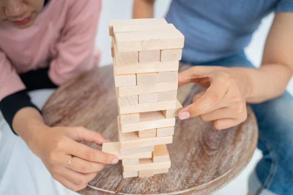 Two players hands are trying to take the wooden block — Stock Photo, Image