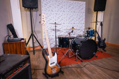 Davul seti, bas gitar ve ses sistemi olan bir oda.