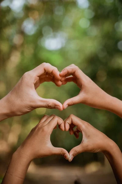 Hand showing love with finger with blur background — Stock Photo, Image