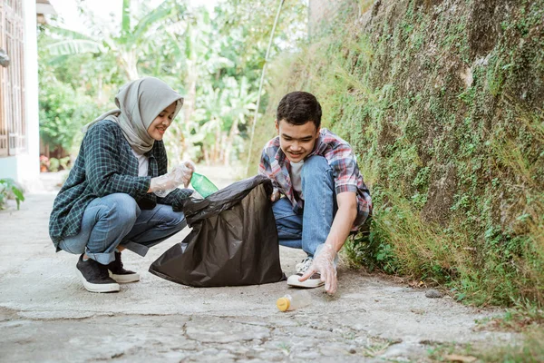 Dwóch szczęśliwych nastolatków zbierających śmieci — Zdjęcie stockowe