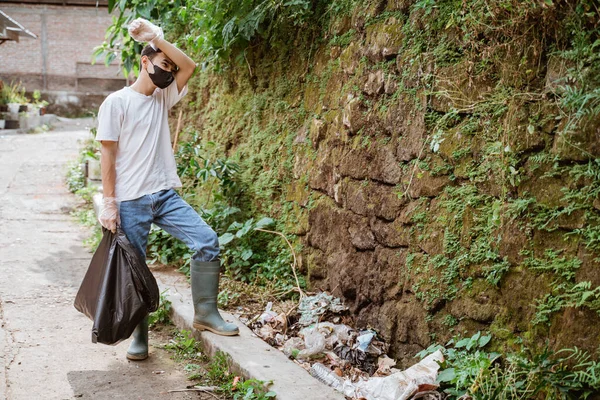 Genç gönüllüler çöpleri toplayarak çevreyi temiz tutuyorlar.