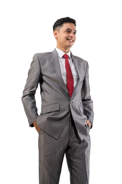 Homem de negócios bonito colocar o braço em um bolso isolado sobre fundo branco — Fotografia de Stock