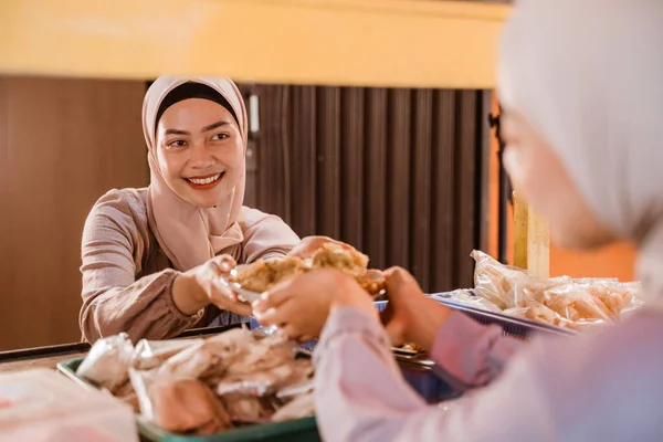 muslim asian woman preparing her food stall