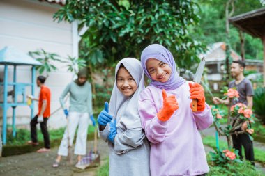 İki gülümseyen kız eldiven takıyor.