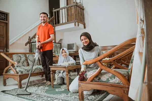 Asian mom and dad smiling while cleaning with vacuum — Stock Photo, Image