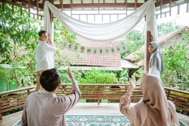 İki çocuk kâğıt zincir süslemesi yaptırmış.