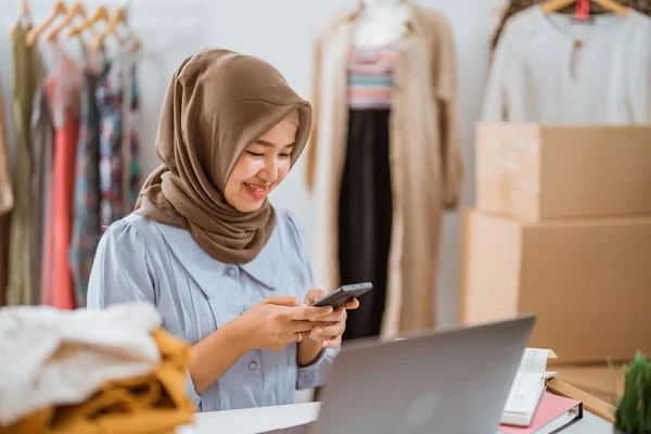 stock image muslim businesswomen using mobile phone working