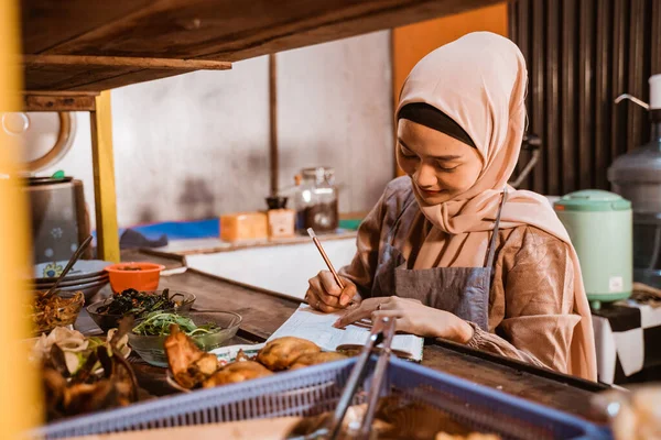Muslim jídlo stánek majitel napsat poznámku při práci — Stock fotografie