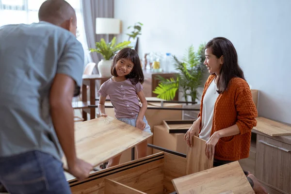 Familia con niños montando muebles en su nueva casa — Foto de Stock