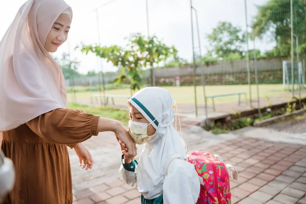 Anak muslim mencium tangan ibunya sebelum memasuki sekolah — Stok Foto