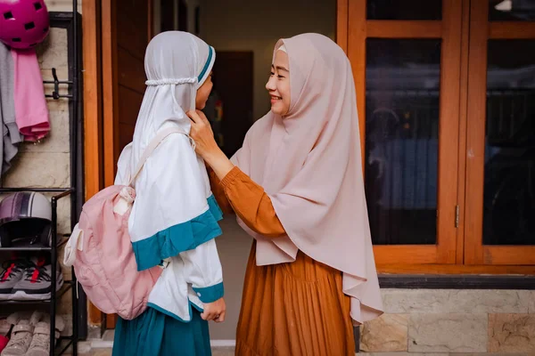 Adorable young mother and daughter preparing for school — Stock Photo, Image