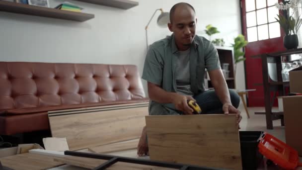 Jovem asiático masculino montagem móveis por si mesmo — Vídeo de Stock