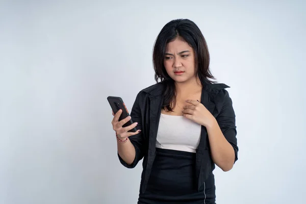 Sad asian woman while using mobile on isolated background — Stock Photo, Image