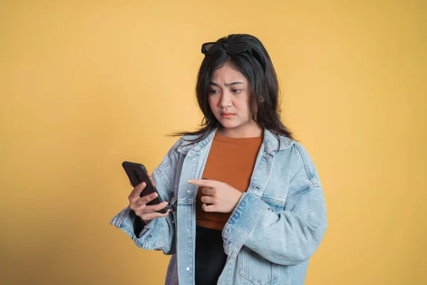 Jonge vrouw geschokt tijdens het gebruik van mobiele telefoon — Stockfoto