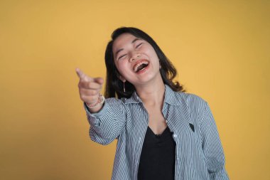 İzole edilmiş arka planda parmak işareti yapan Asyalı kadın.