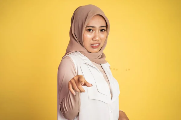 cynical asian muslim woman expression while standing over white