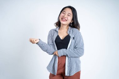 Heyecanlı genç kadın kameraya gülümserken avuçlarını açıyor.