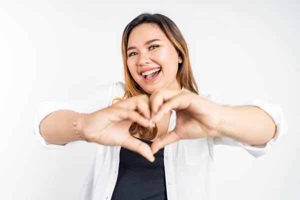 Jonge vrouw lachen met hart vorm met vingers — Stockfoto