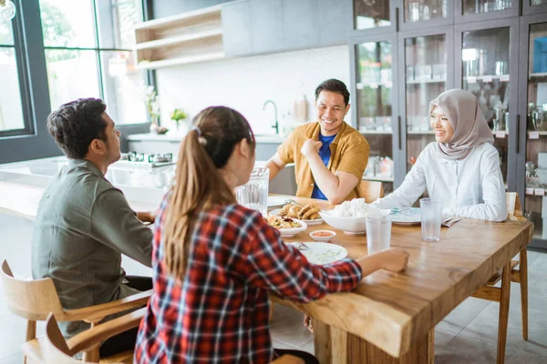 Friends having fun eating lunch together at home with traditional food — Stock Photo, Image