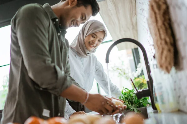 Unga par förbereder läcker mat tillsammans hemma. — Stockfoto