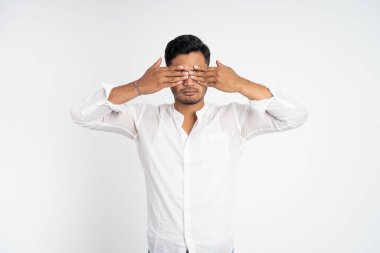 Rahatsız edici bir ifadesi olan, iki eli kapalı bir adam.